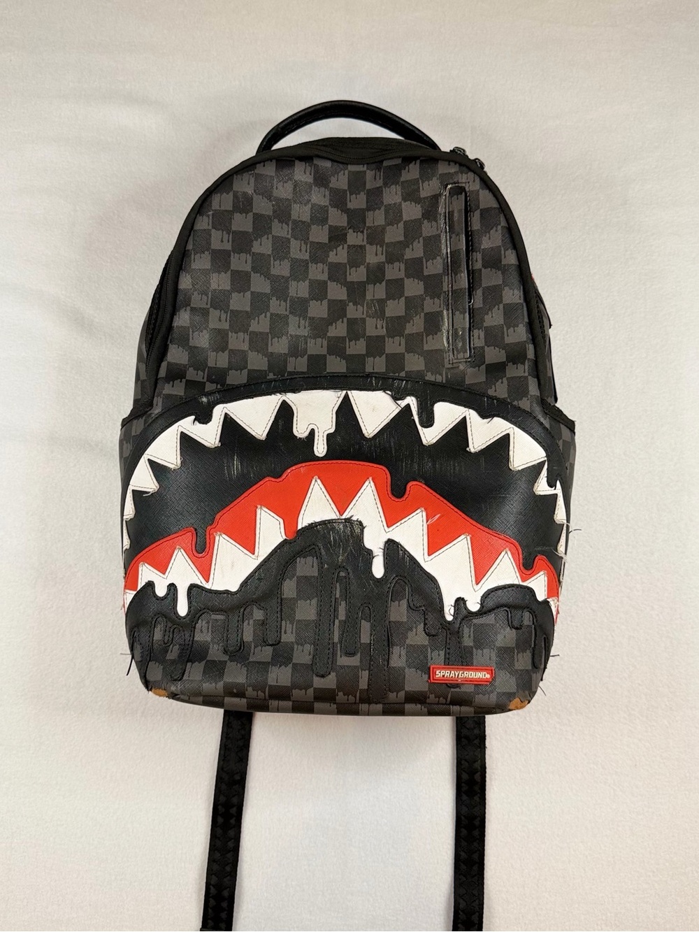 Sprayground Black Checkered Backpack with White and Red Shark Graphic